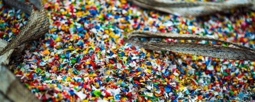Sack of sorted multicoloured shredded plastic garbage at waste recycling factory